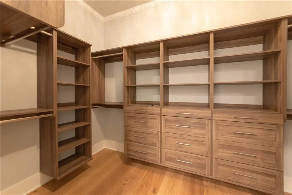 Spacious closet featuring light hardwood / wood-style floors