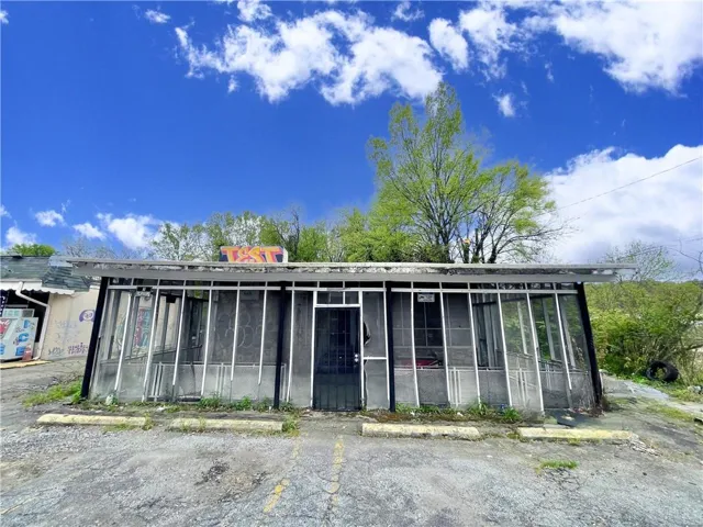 View of property with uncovered parking
