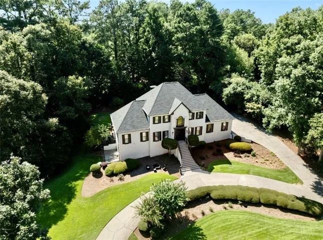 Two-story residence with a multi-gabled roofline and white exterior