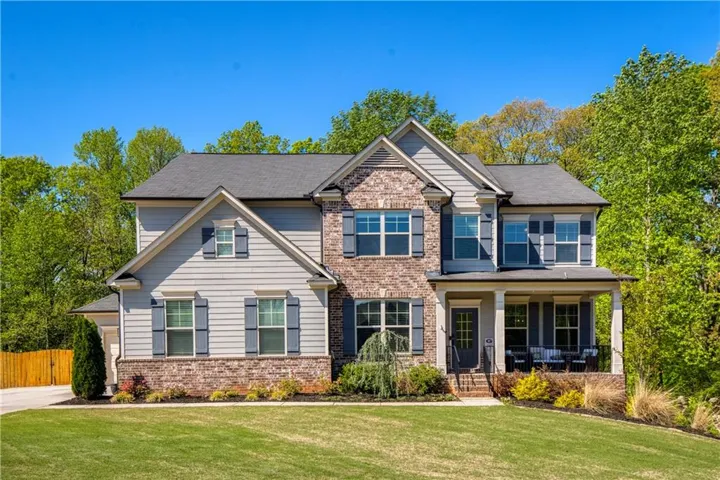 Craftsman house featuring brick siding and covered porch