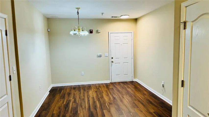 Wood-finish flooring, neutral wall tones, and white trim