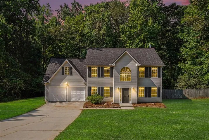 Two-story residence featuring light gray siding and a dark shingle roof