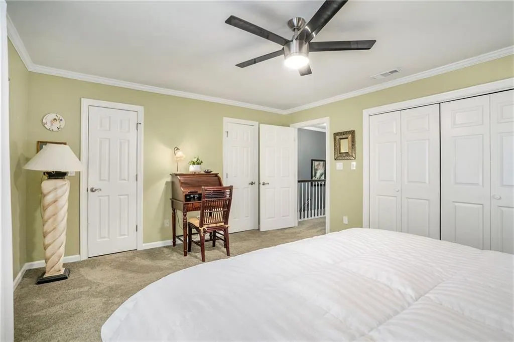 Carpeted bedroom with  3 closets