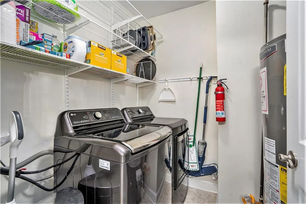 Laundry room featuring water heater and lots of extra storage