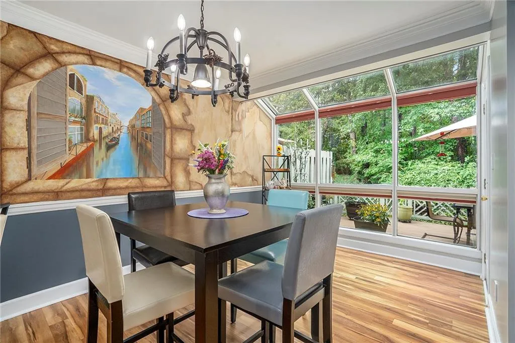Dining space featuring Venetian mural, and a wealth of natural light from the sunroom. Sunroom has useful blinds to control the light, along with a mechanical shade that drops from the ceiling