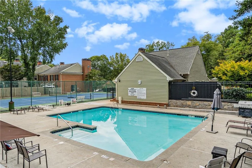 View of community swimming pool with a patio area