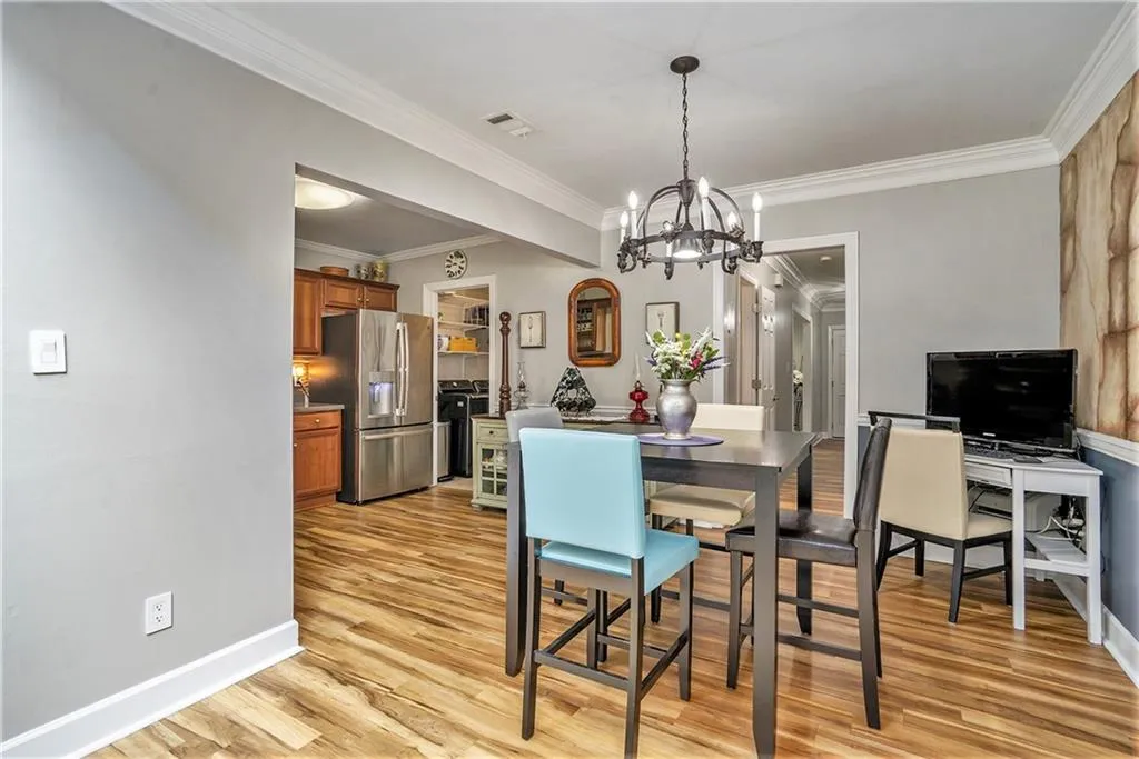 Dining room with crown molding and a notable chandelier