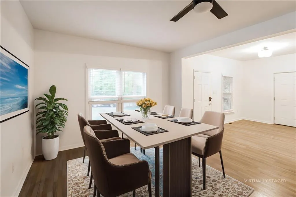 Dining area featuring dark wood-type flooring and ceiling fan