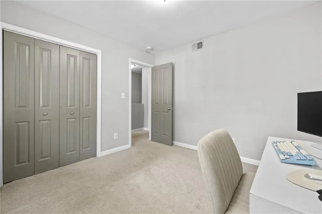 Office with light carpet and baseboards
