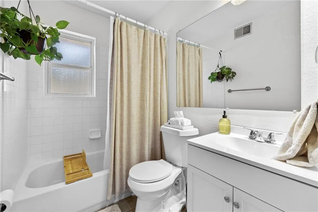 Full bathroom with vanity and shower / bath combination with curtain