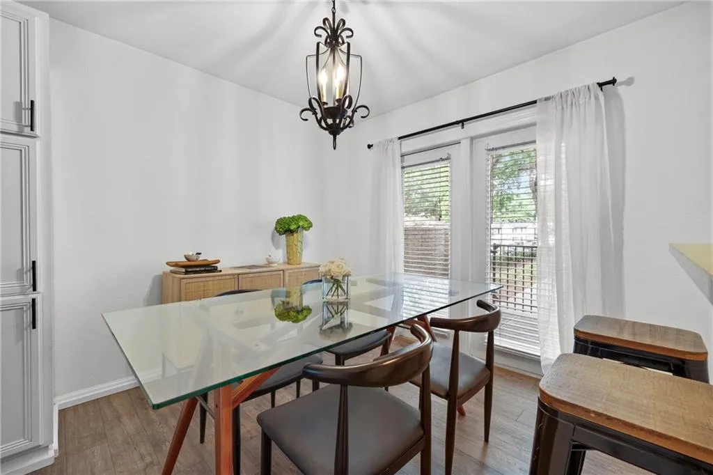Dining space featuring wood finished floors and a chandelier