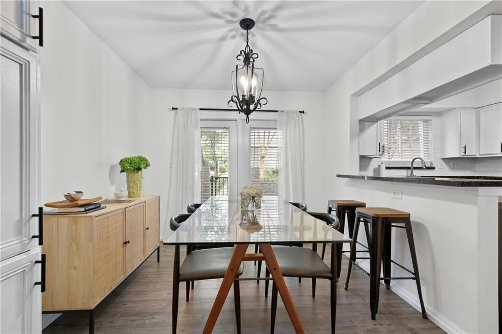 Dining room featuring dark wood-style flooring and plenty of natural light
