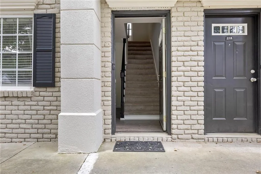 Doorway to property with brick siding