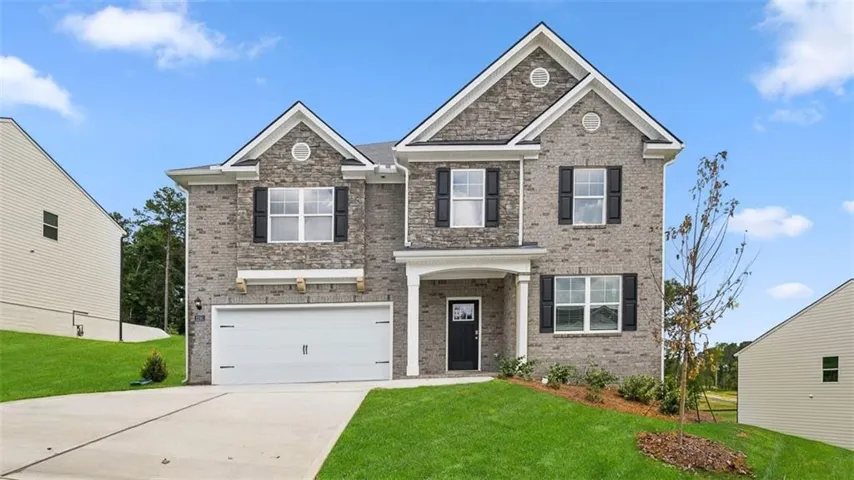Two-story brick exterior with gabled roofline