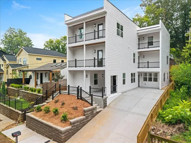 Modern exterior with white horizontal siding and black railings