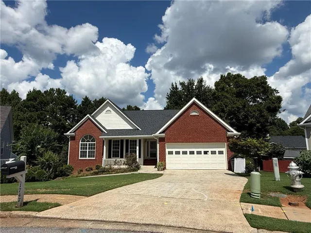 Brick and siding exterior with a gabled roofline