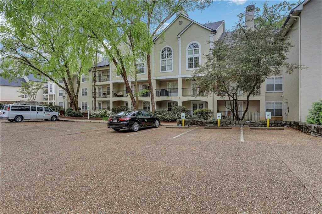 View of building exterior with uncovered parking
