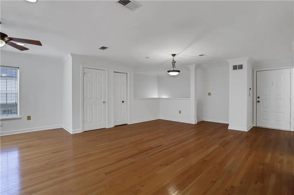 Unfurnished living room with light wood-style floors and ceiling fan