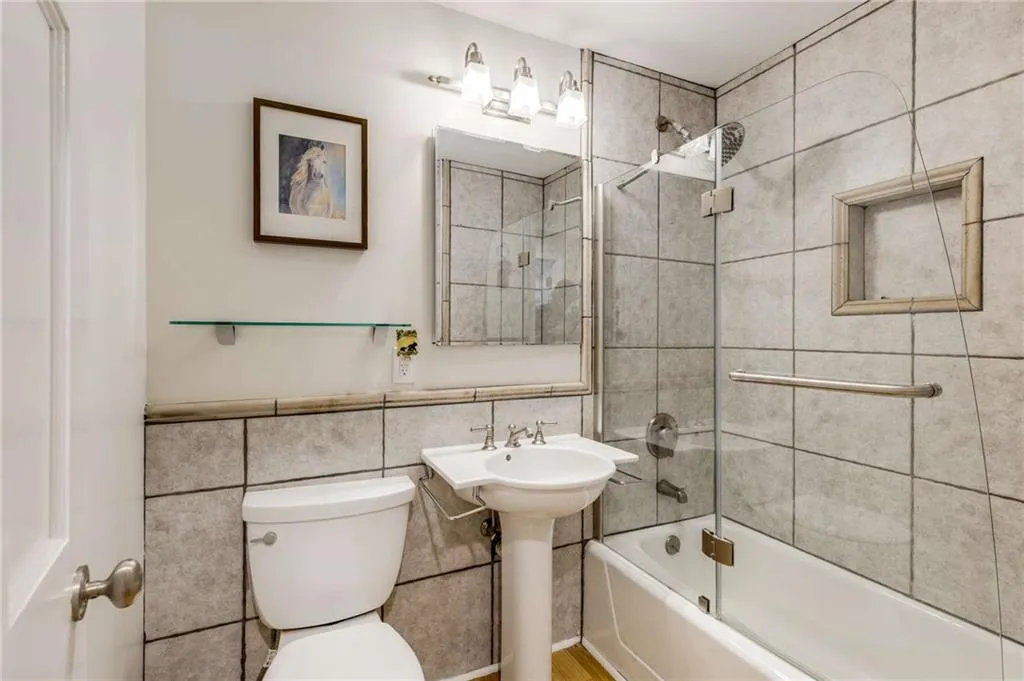 upstairs hall bath
shower / tub combination. Glass shower doors