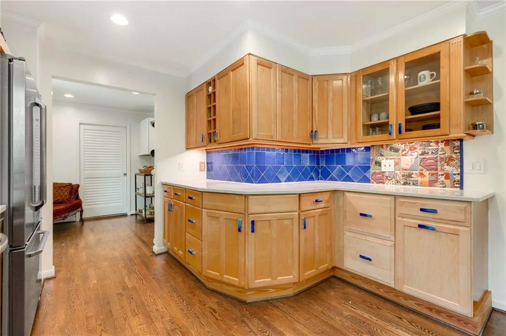 delightful kitchen with whimsical tile backsplash and ornamental drawer pulls