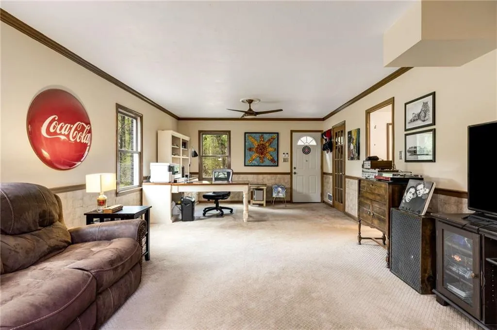 Eclectic downstairs carpeted den/play room and entertainment area. This room has an exterior exit to back yard.