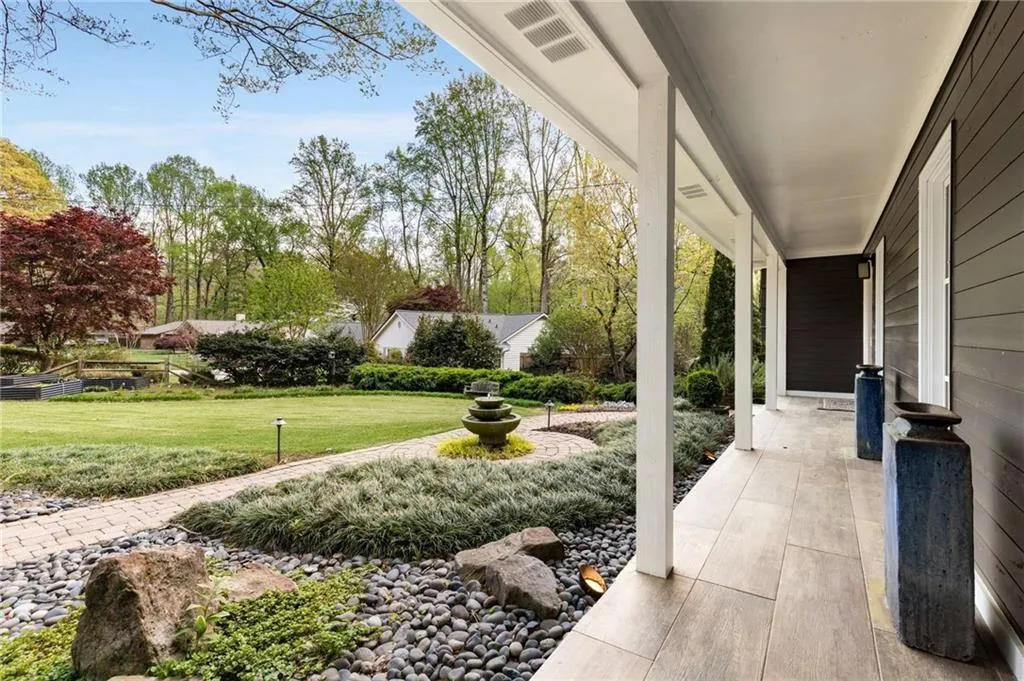 Front porch view of stone walkways and water feature.