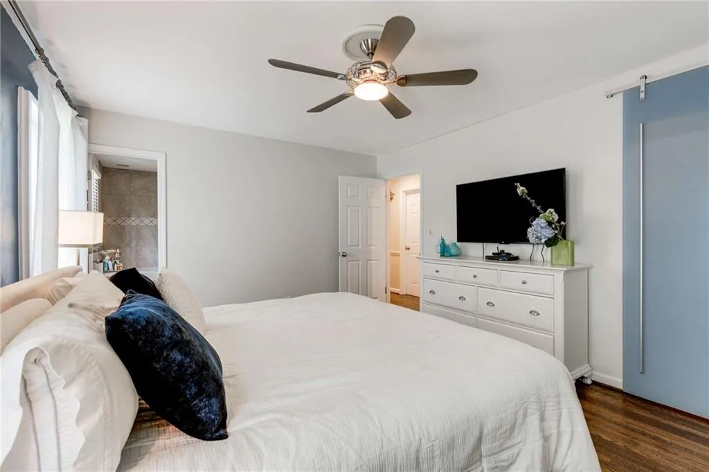 Bedroom with track sliding door at closet.