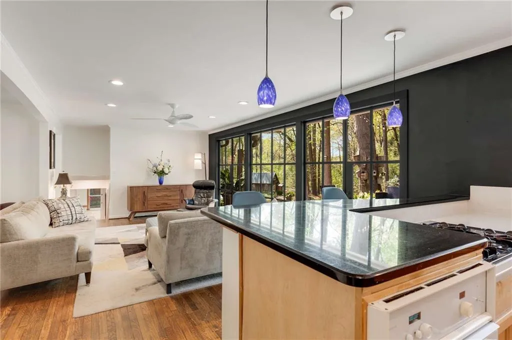 view of Family Room from kitchen. Enjoy watching the seasons change from every room.