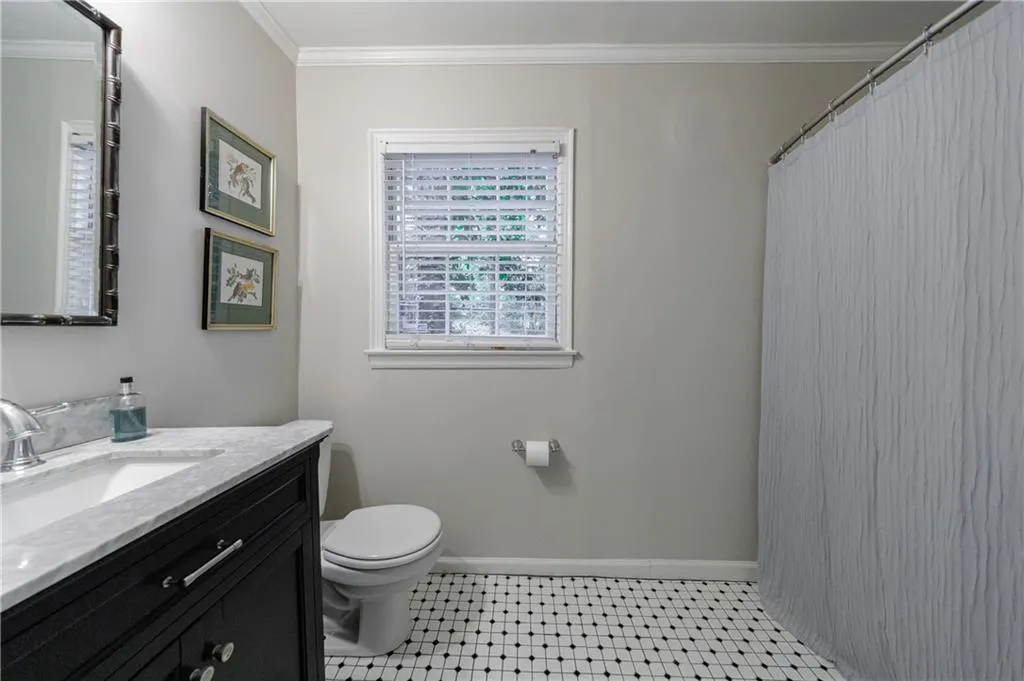 Full bathroom featuring vanity, crown molding, tile patterned floors, and a shower with shower curtain