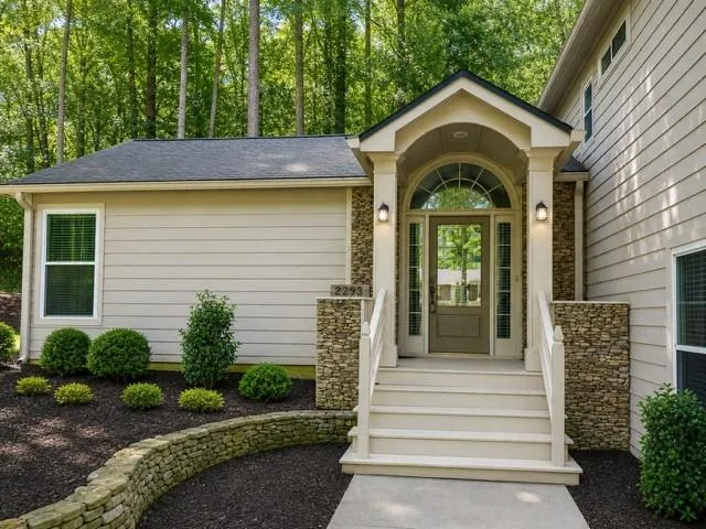 AI improved image. Inviting front entry featuring stone accents, a covered porch, and a transom window above the entryway