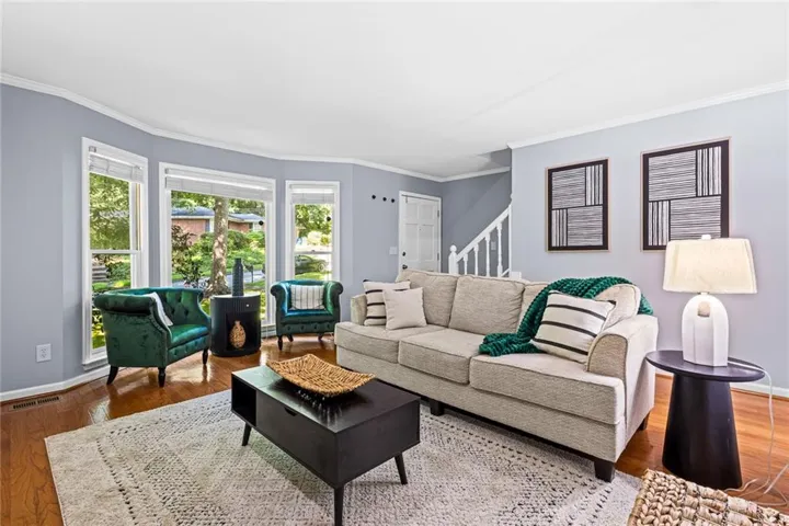 Hardwood / wood-style floors, crown molding, a fireplace, and built in shelves