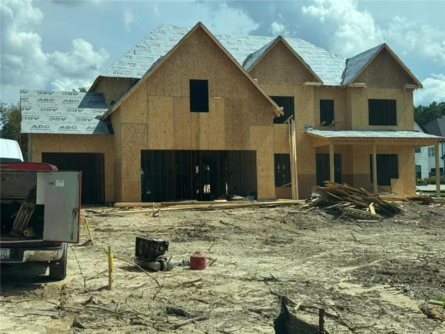 Two-story construction featuring multiple gables, an attached two-car garage, and a covered front porch