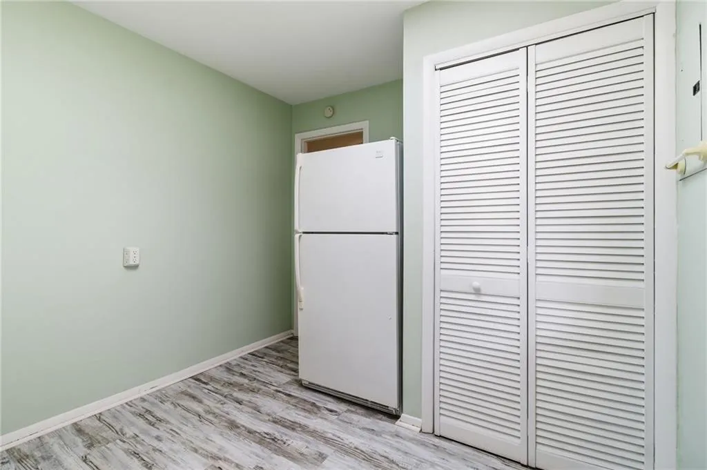 Kitchen featuring freestanding refrigerator and light wood-style floors