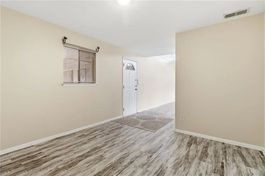 Empty room featuring wood finished floors and baseboards