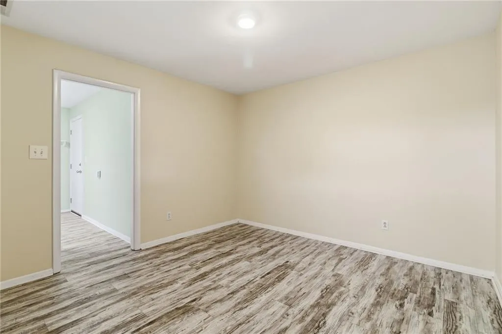Spare room with wood finished floors and baseboards