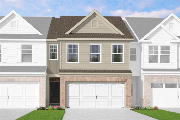 Contemporary townhome exterior featuring a two-car garage, brick facade, neutral siding, and a gabled roofline