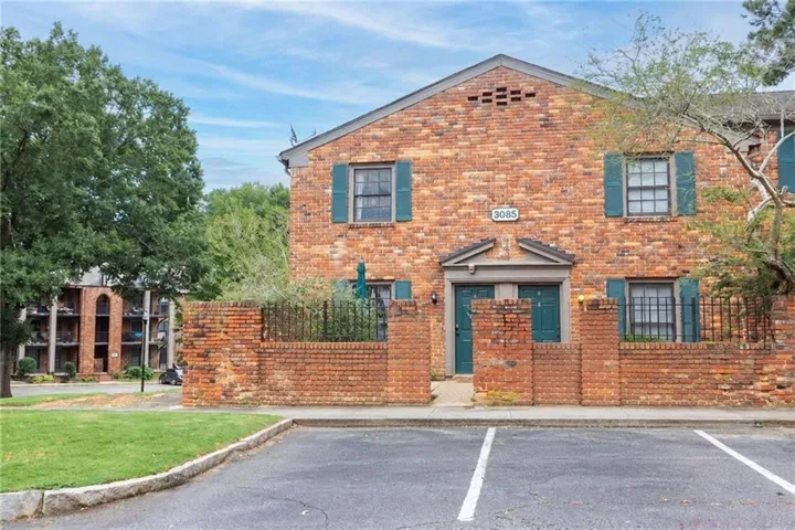 Brick exterior featuring teal shutters and doors