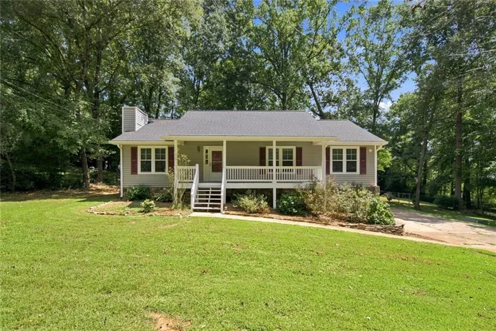 Single-story residence featuring light gray siding with red shutters, a covered front porch, and a gable roof