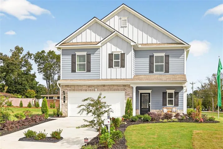 Contemporary two-story residence featuring light blue siding with white board and batten accents