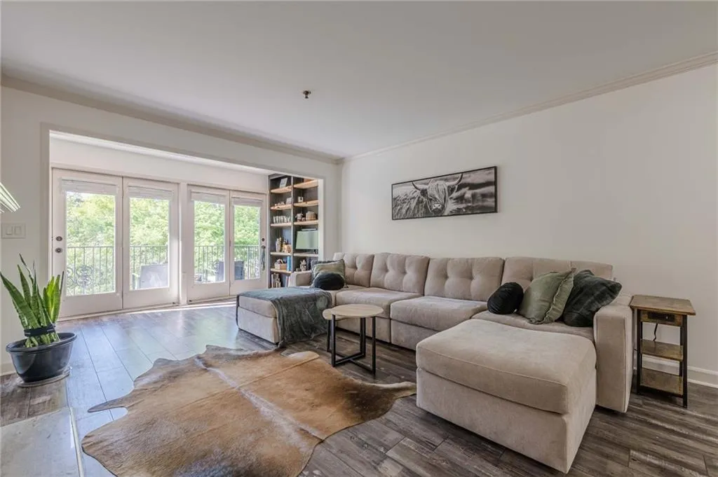 Living area featuring crown molding and wood finished floors