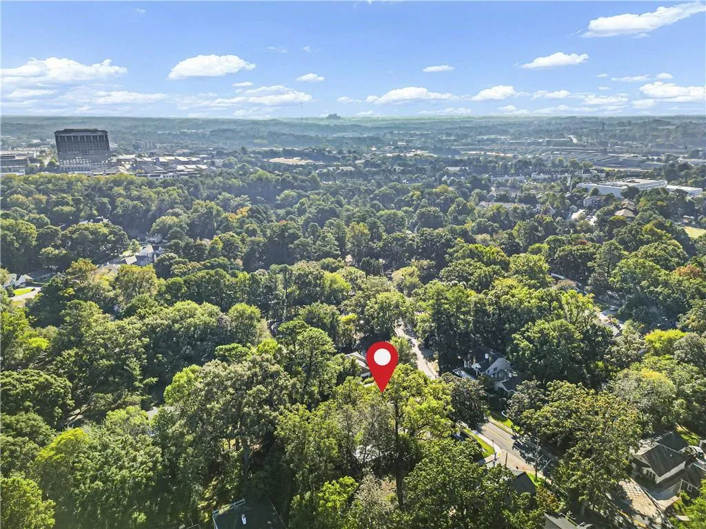 Aerial perspective featuring mature tree canopy and established residential surroundings