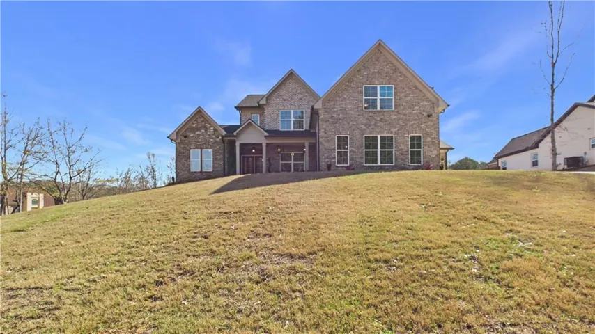 View of front of home with brick siding and a front lawn