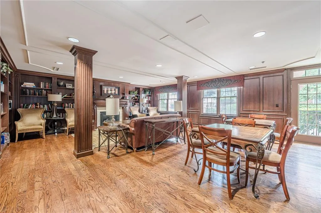 Dining space featuring decorative columns, light wood-style flooring, and recessed lighting