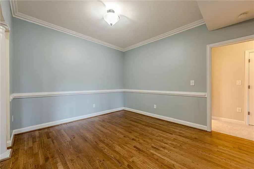 Spare room featuring wood finished floors and ornamental molding