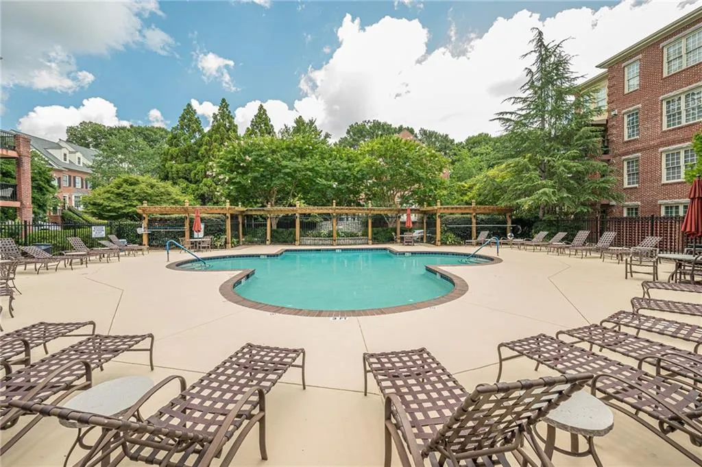 Community pool with a pergola and a patio area
