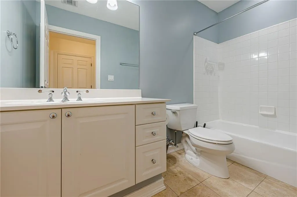 Bathroom featuring vanity, tile patterned floors, and shower / tub combination