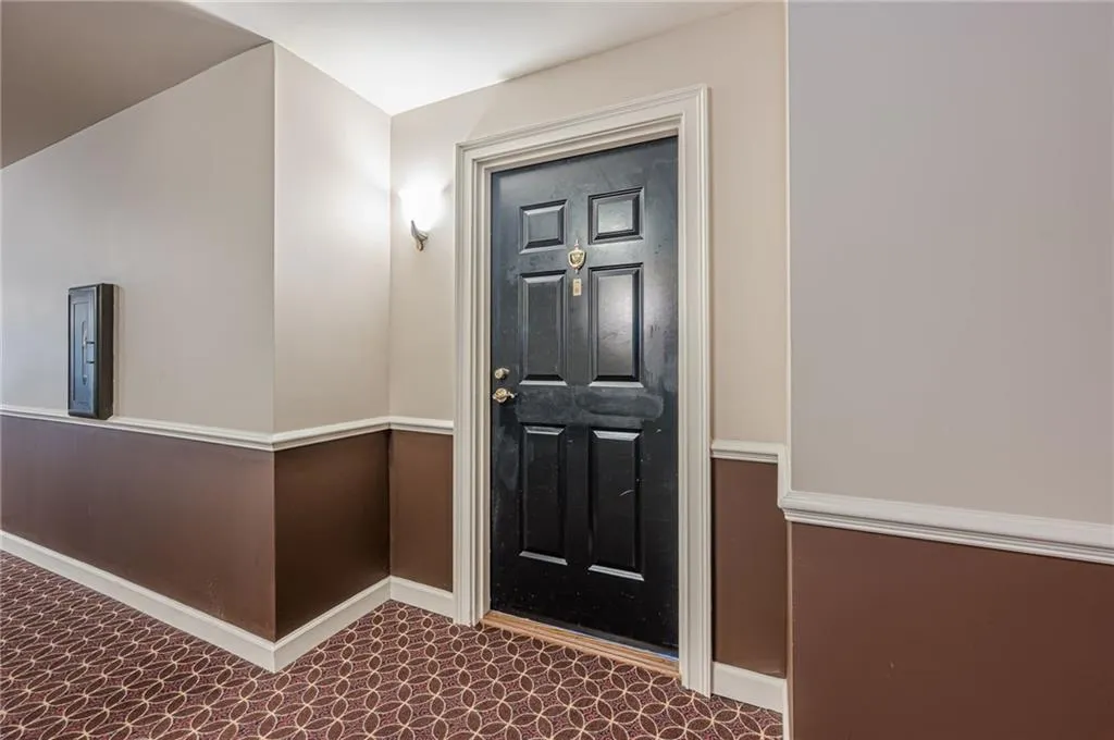 Carpeted entrance foyer featuring baseboards