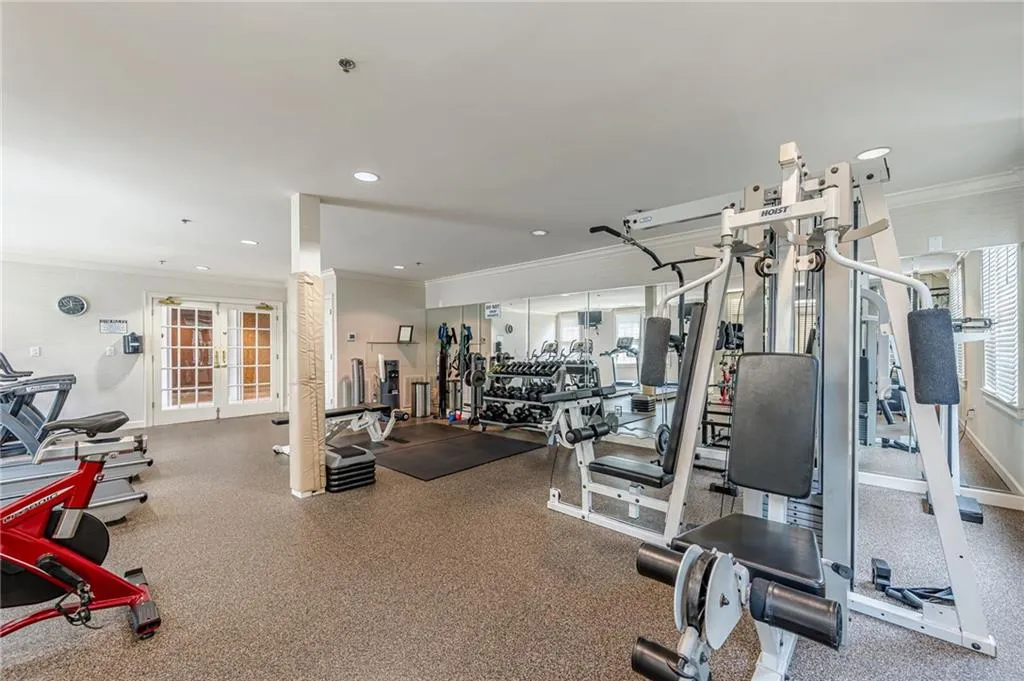 Gym with ornamental molding and recessed lighting