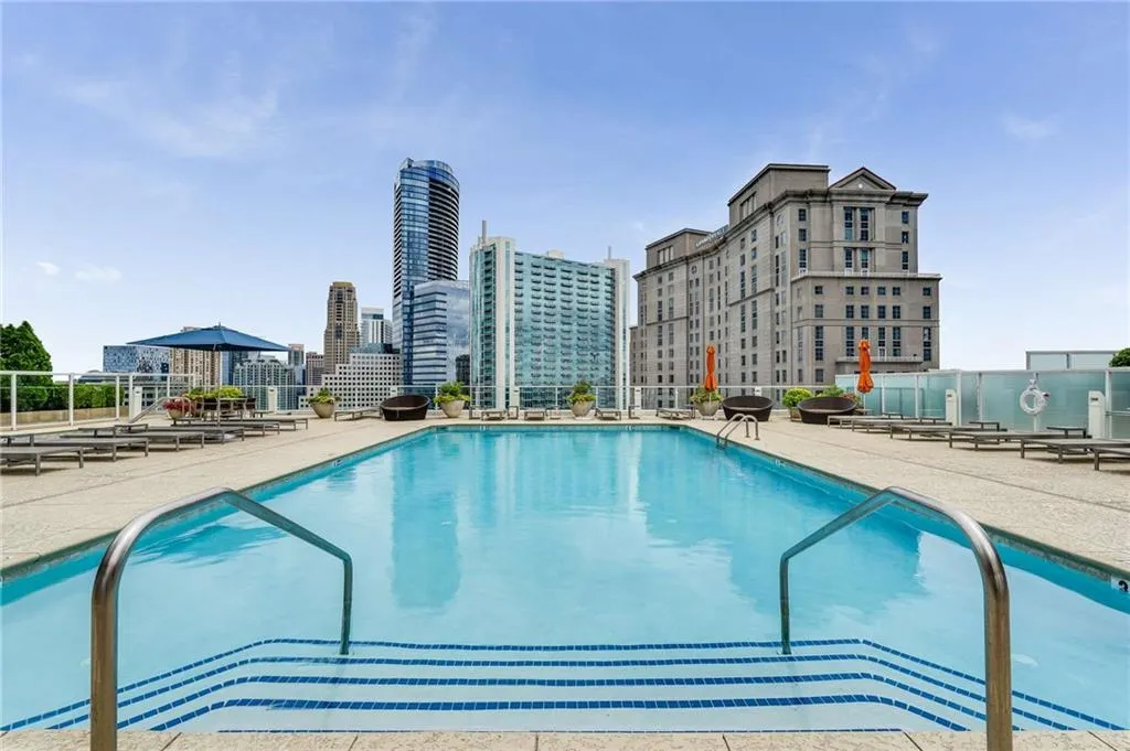 Community pool featuring a patio and a view of city