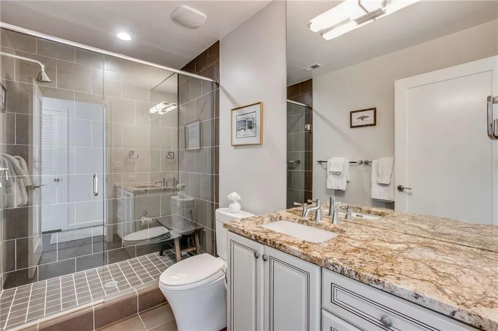 Bathroom featuring vanity, a shower stall, and tile patterned flooring
